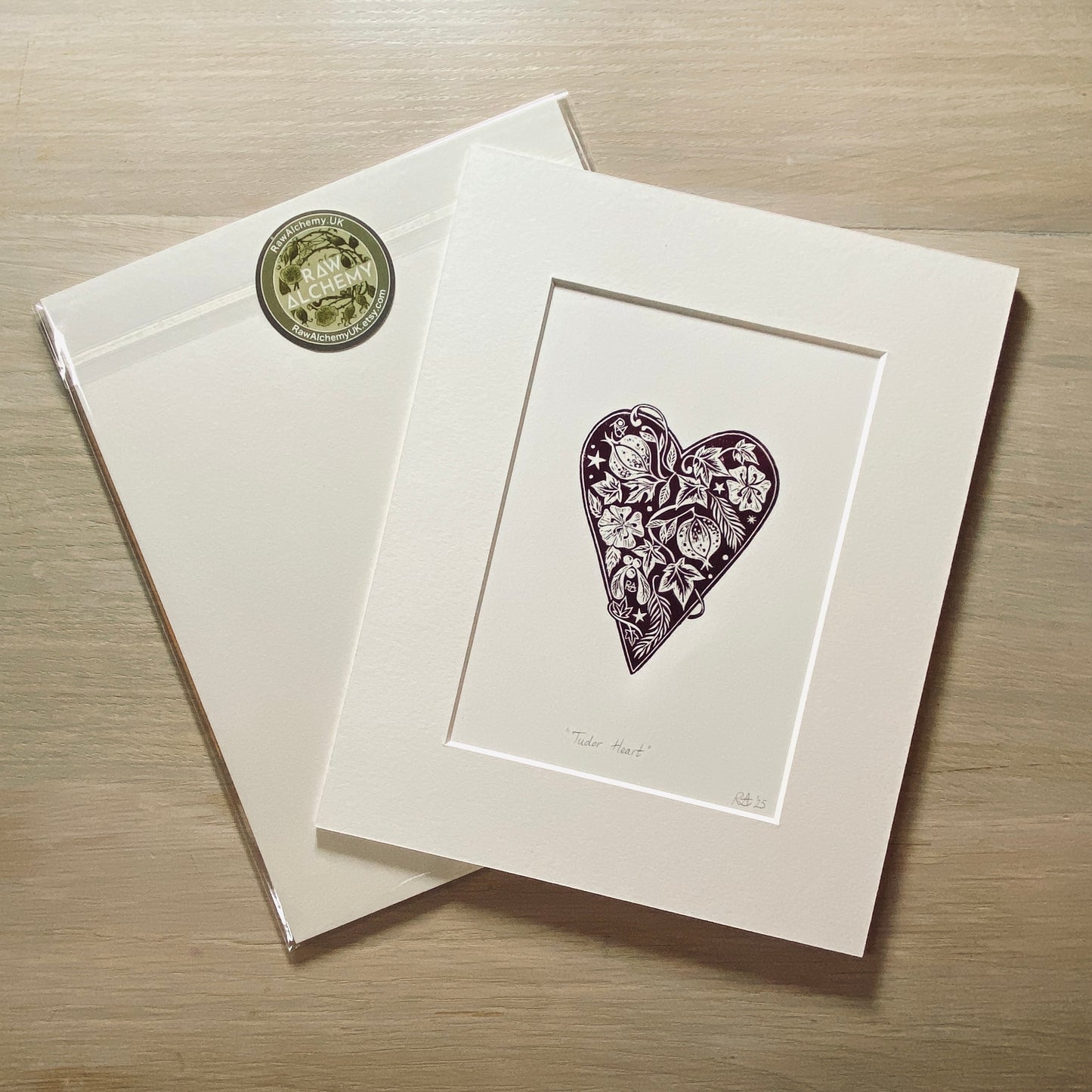 Matted artwork of a heart design on a wooden surface