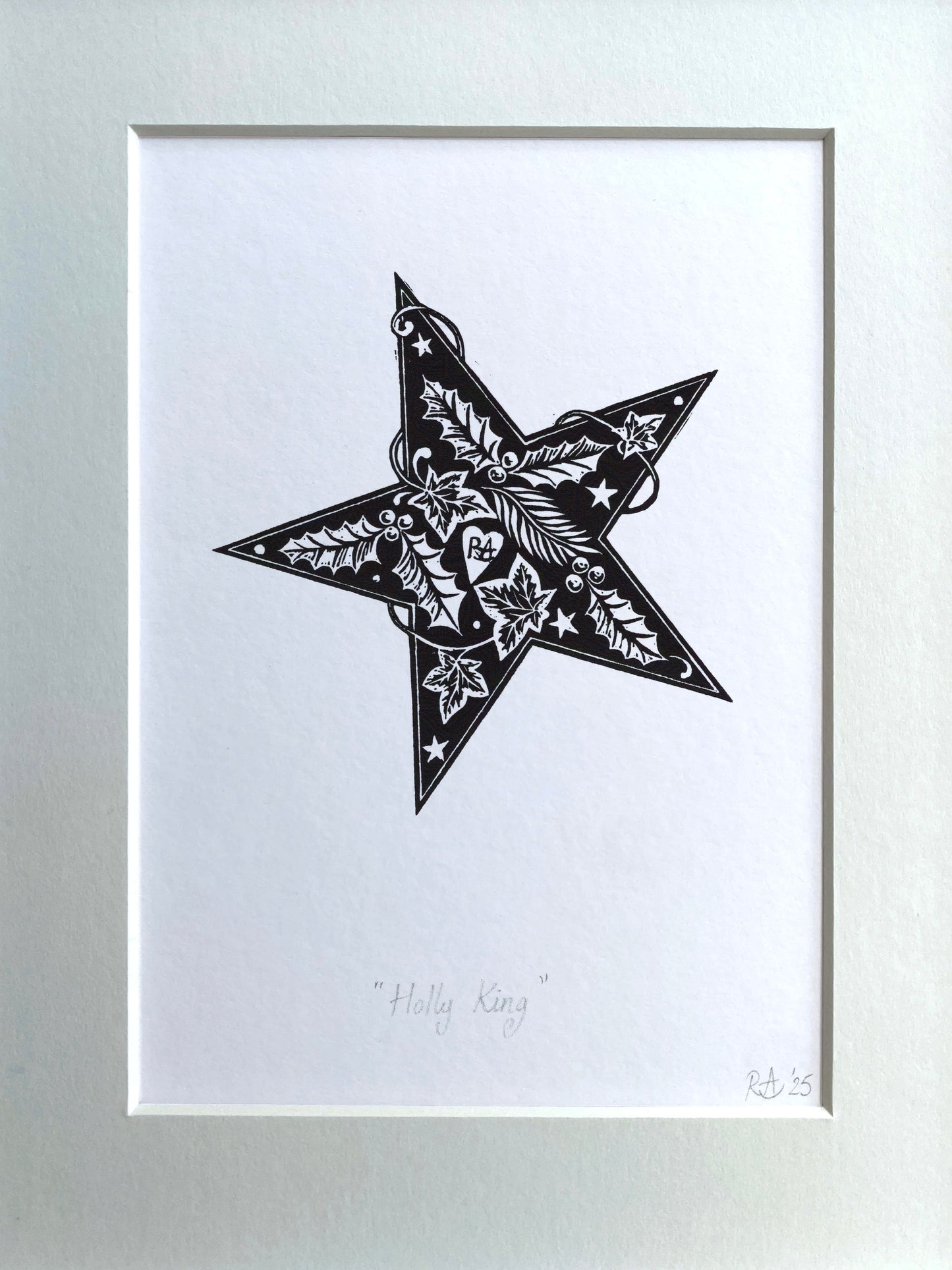 Framed artwork of a black star with intricate patterns on a white background
