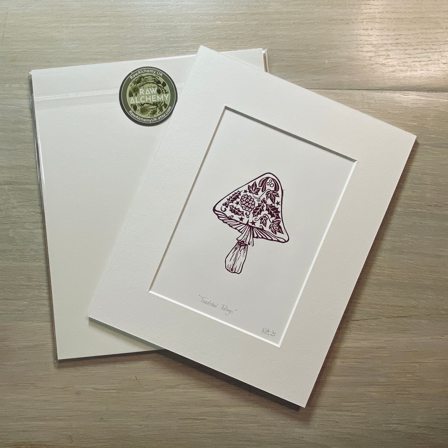 Matted artwork of a floral-patterned mushroom on a wooden surface