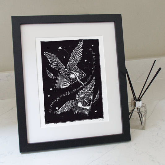 Framed black and white artwork with a winged creature and text on a white surface.