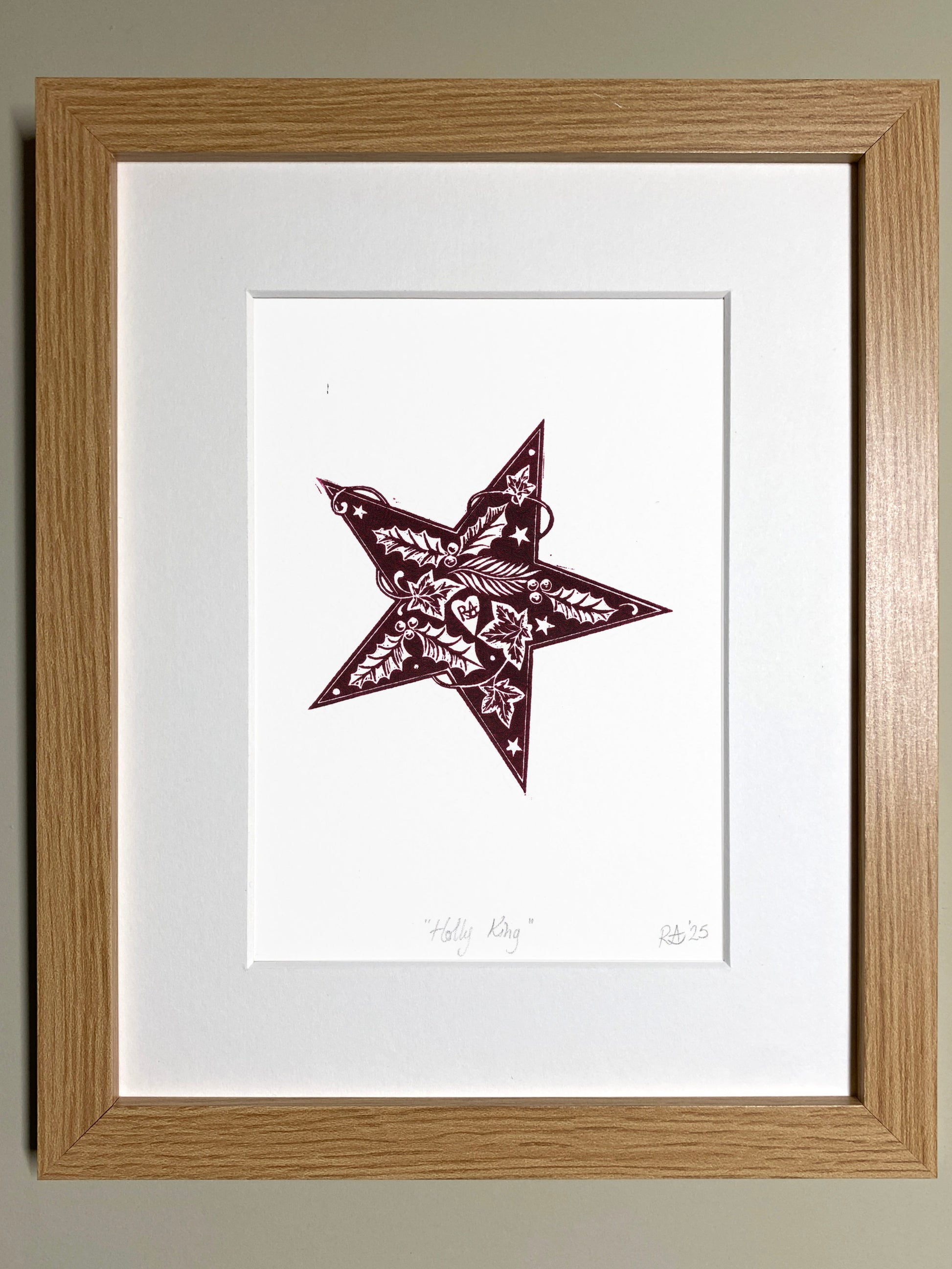 Framed artwork of a star with intricate patterns on a white background