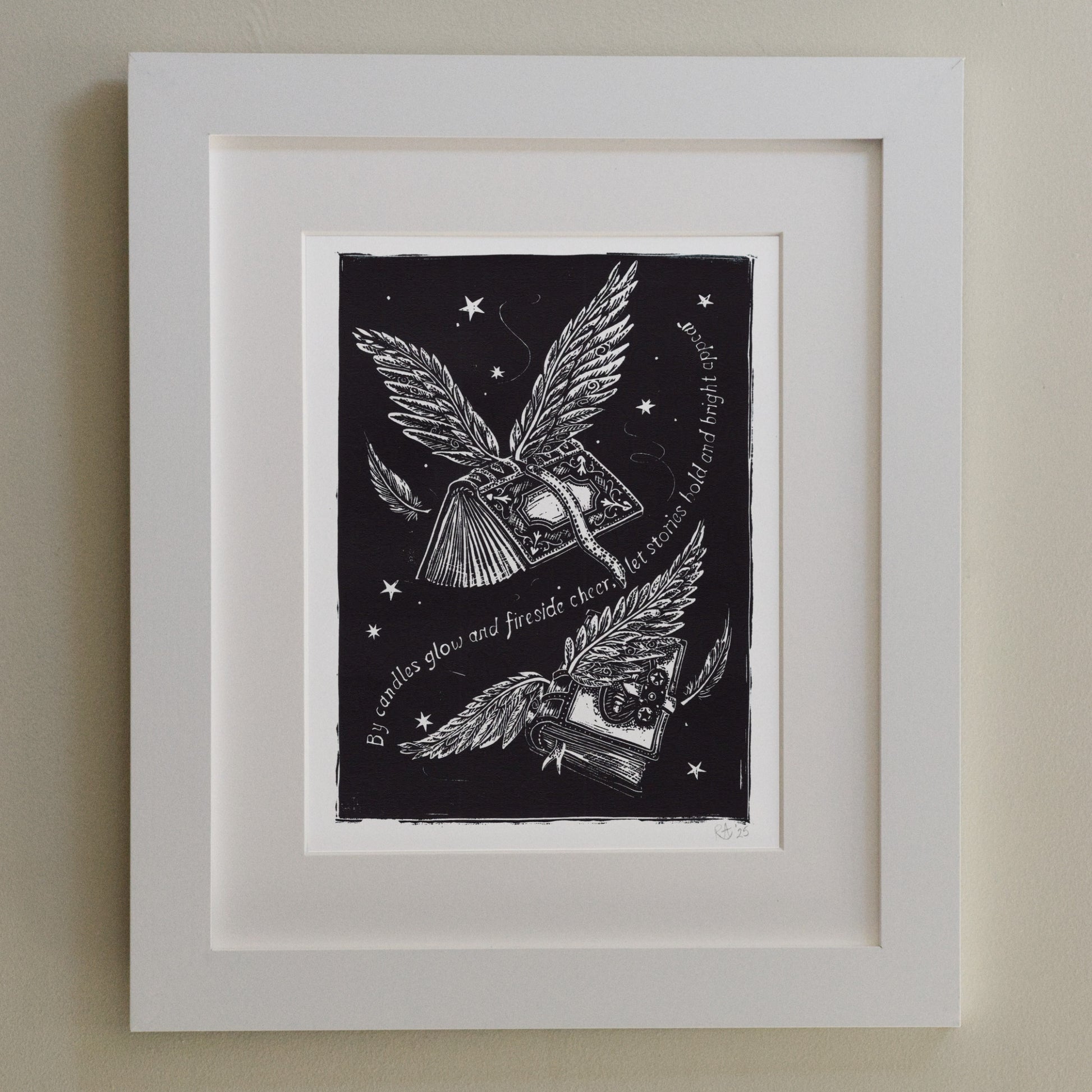 Framed artwork with black and white illustration of wings and text on a dark background.