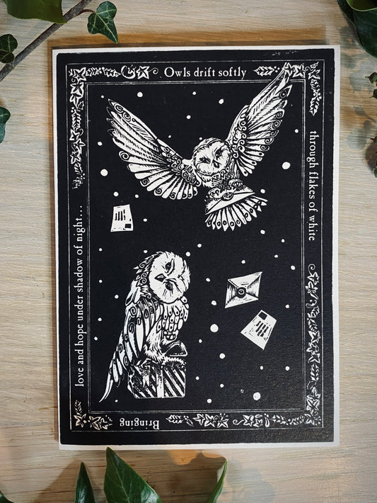 Black and white illustration of owls with decorative text on a wooden surface