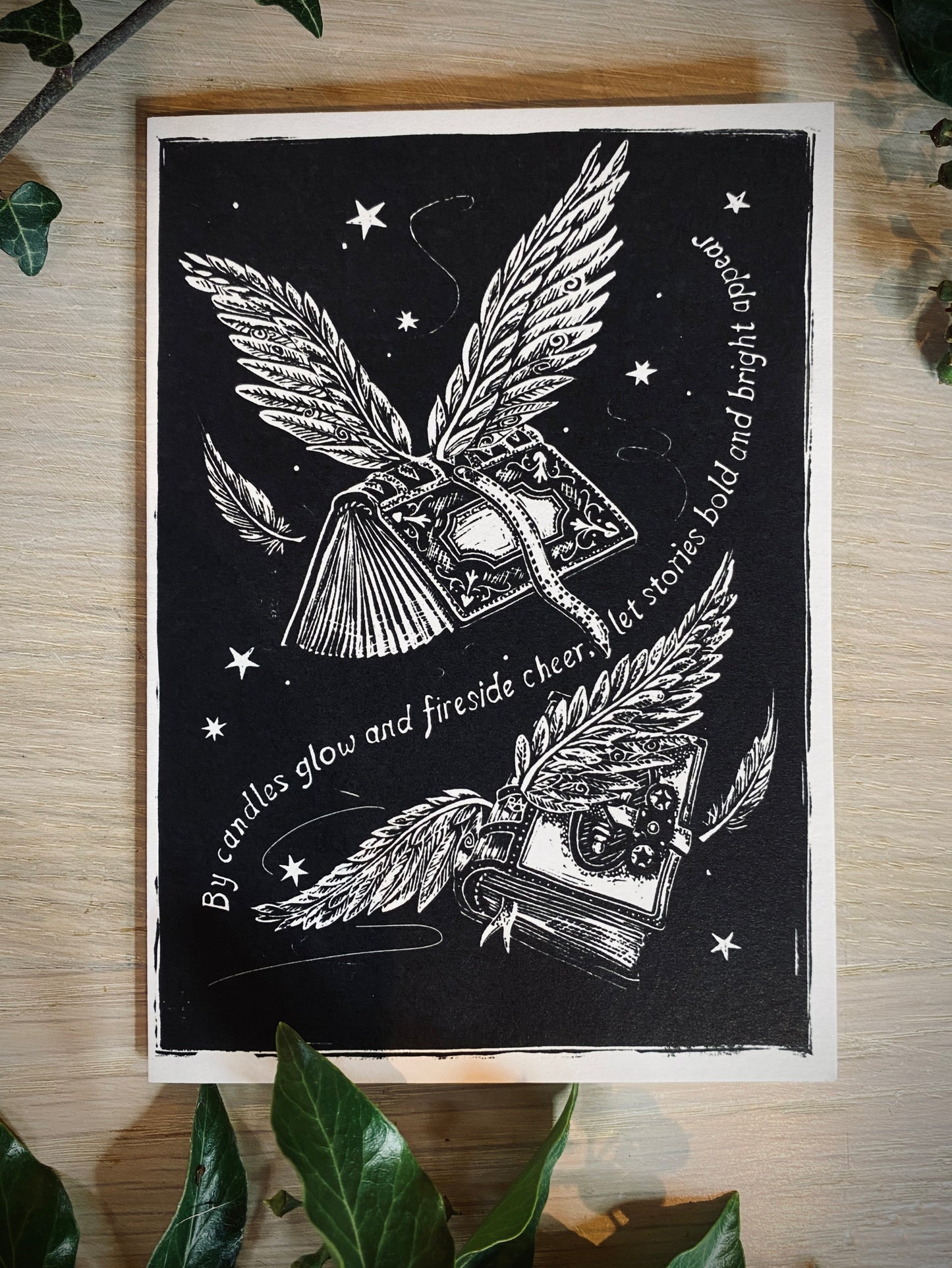 Black and white illustration of books with wings on a wooden surface.