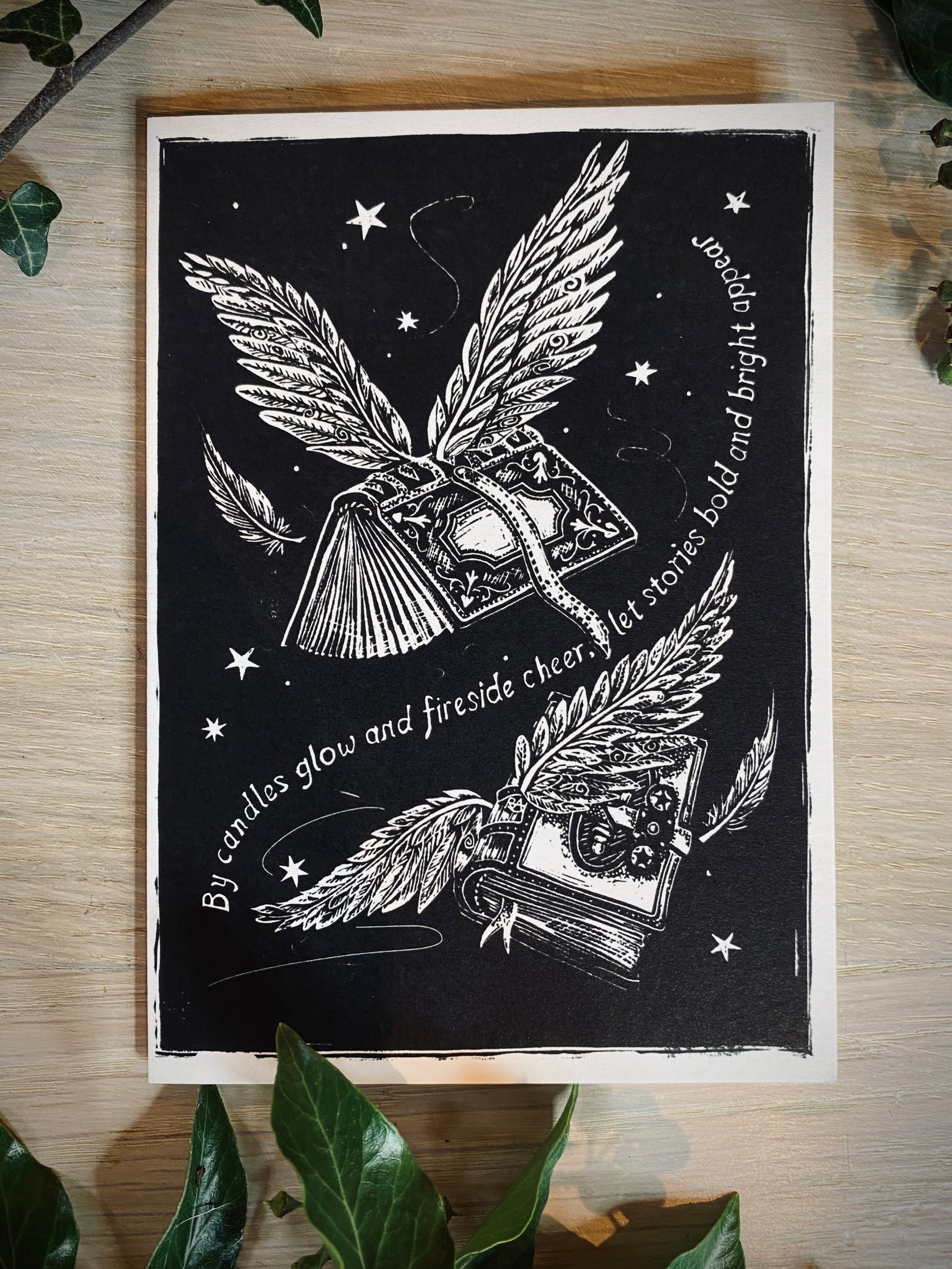 Black and white illustration of books with wings on a wooden surface.