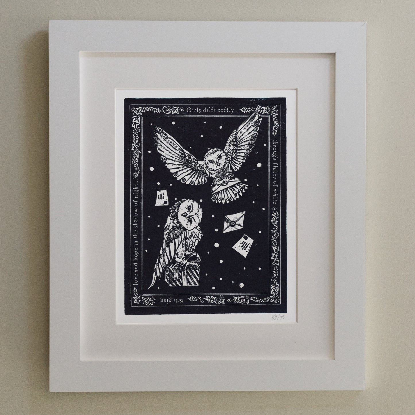 Framed artwork with owls and text on a dark background