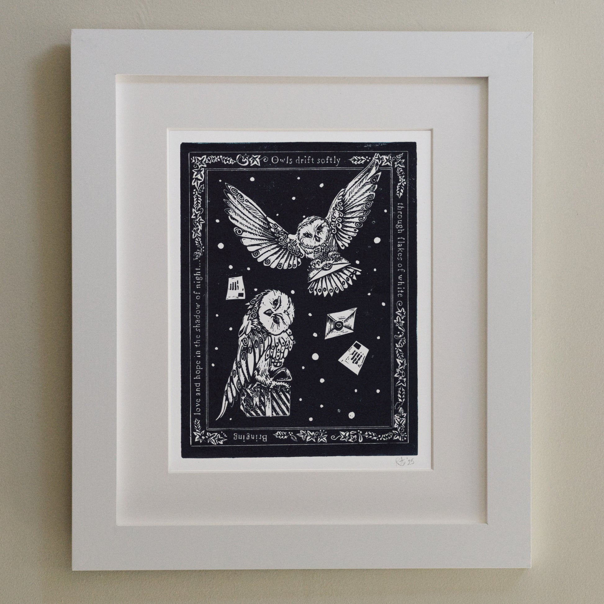 Framed artwork with owls and text on a dark background