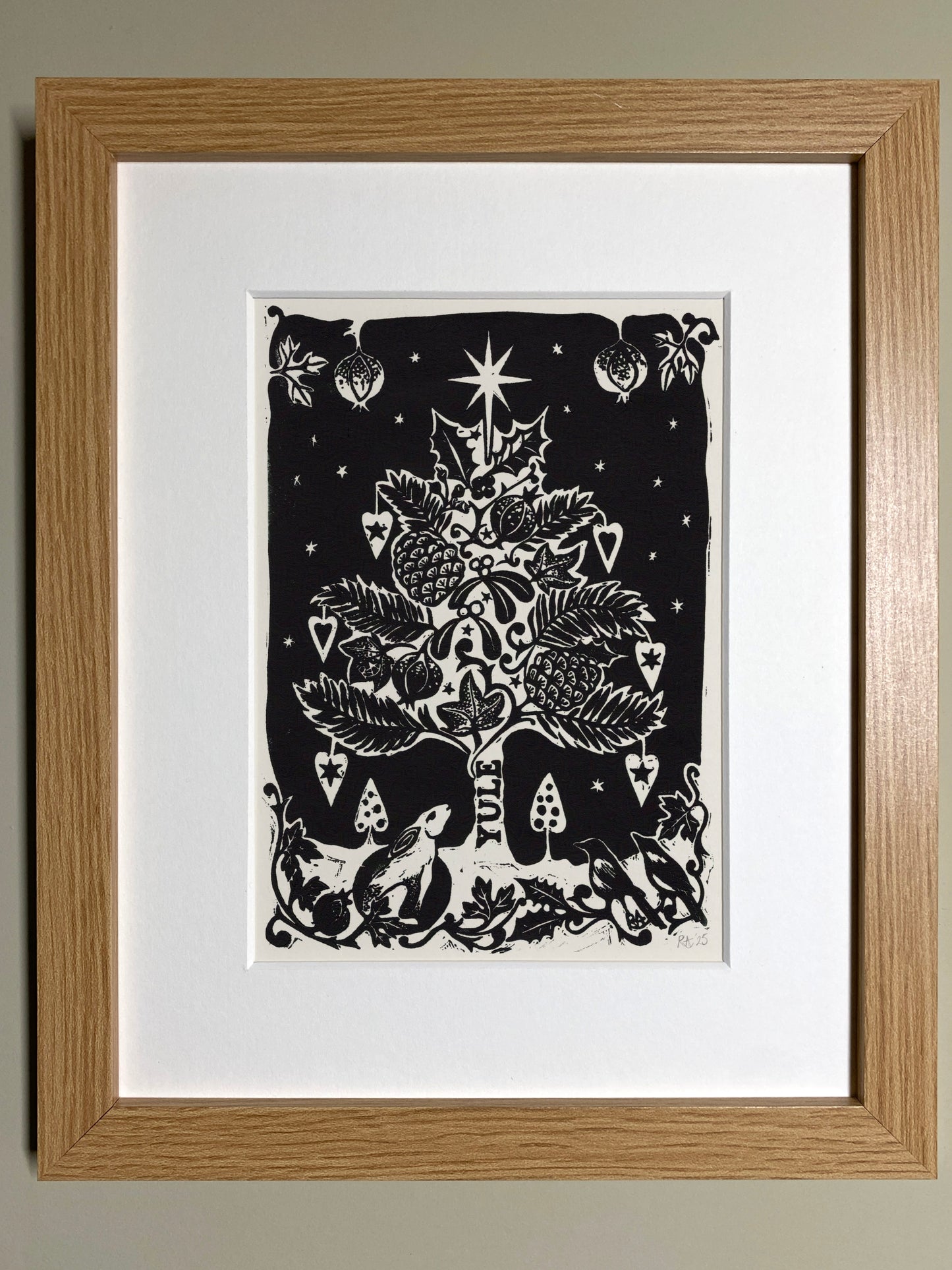 Framed artwork of a black and white Christmas tree design on a white background