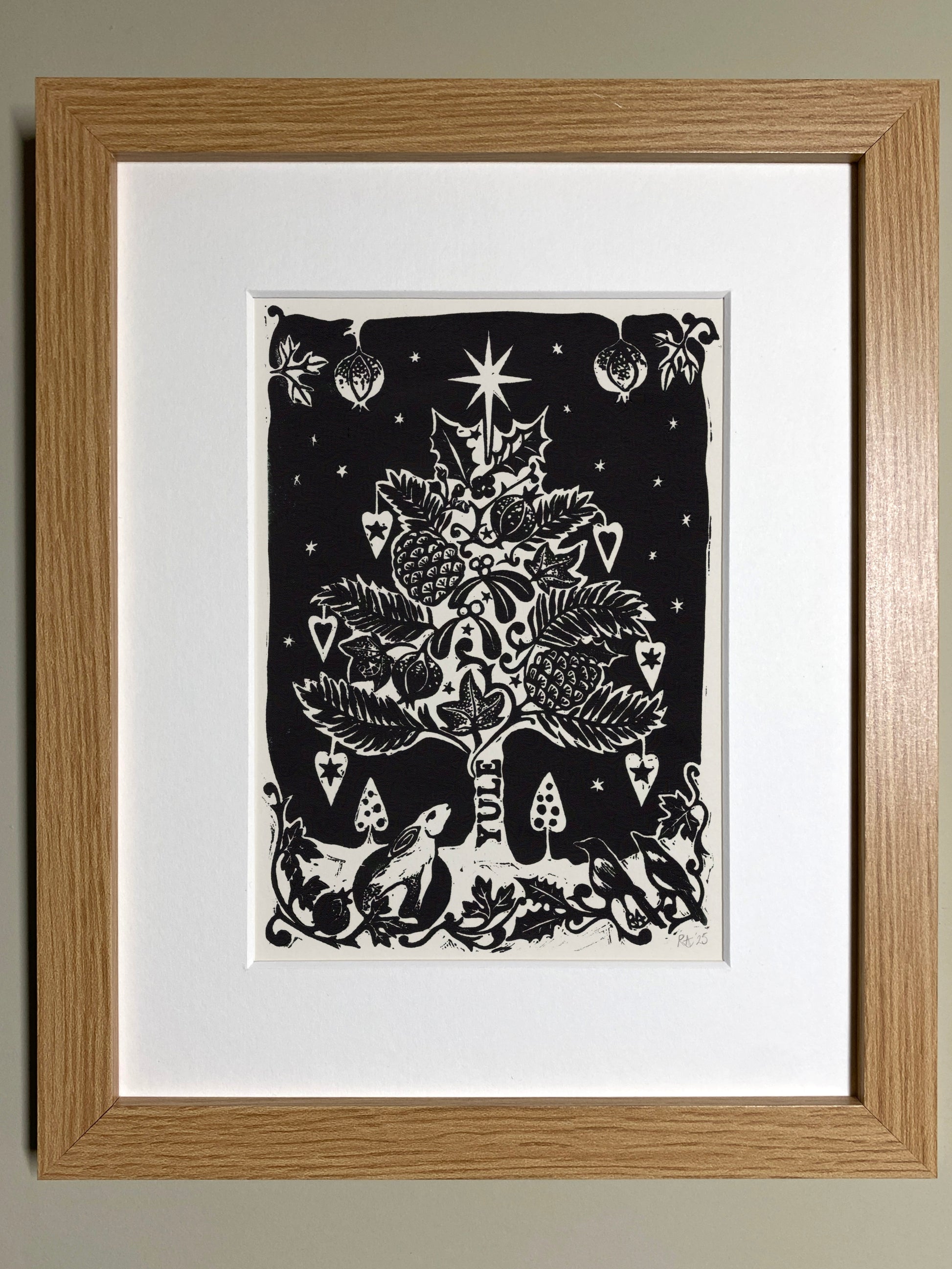 Framed artwork of a black and white Christmas tree design on a white background