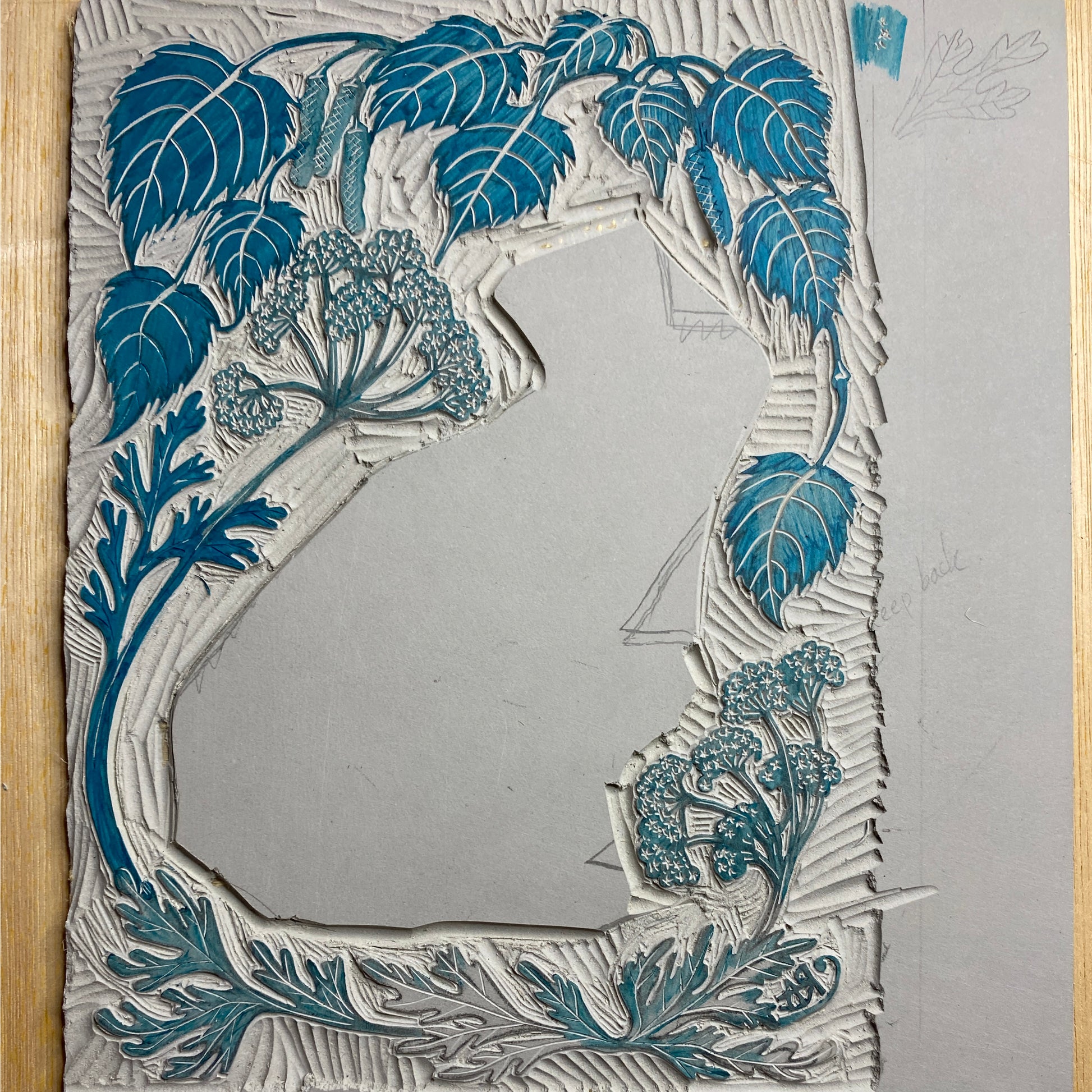 Decorative mirror with blue floral frame on a gray background