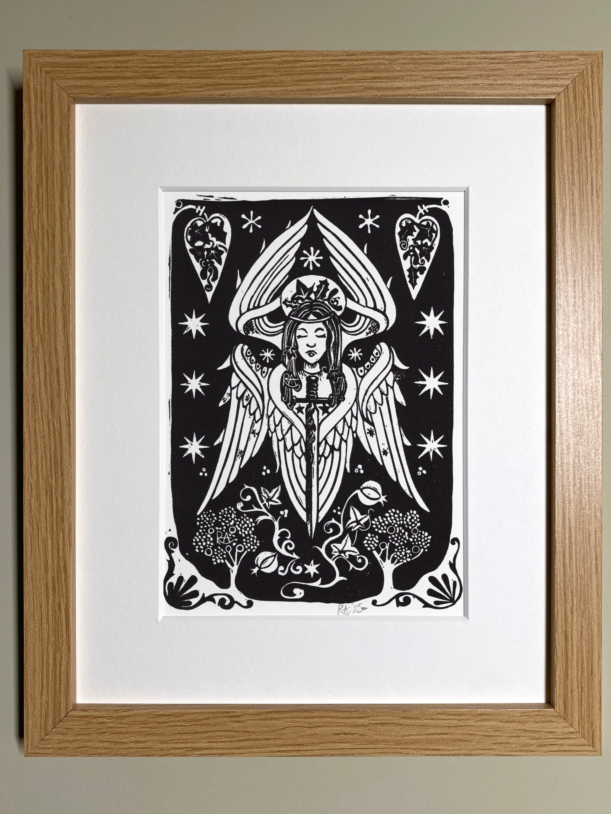 Framed artwork of a stylized angel with decorative elements on a white background