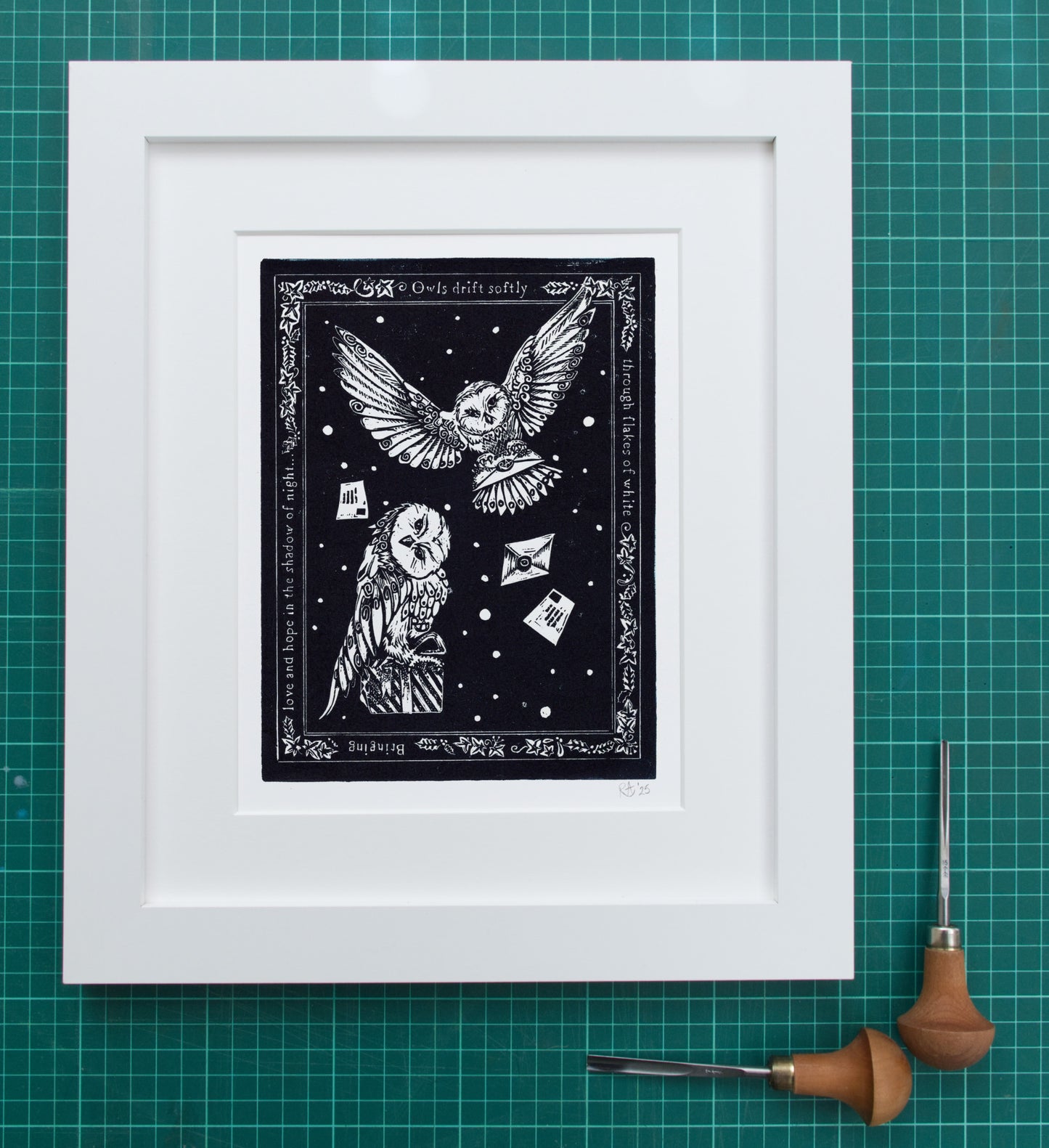 Framed black and white artwork of owls on a grid background