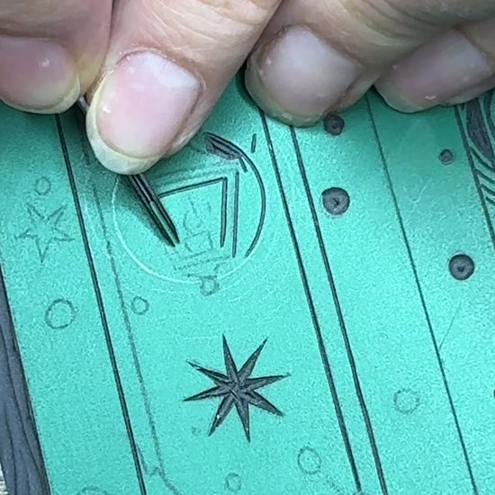 Carving of linoprint block for wardrobe Christmas card