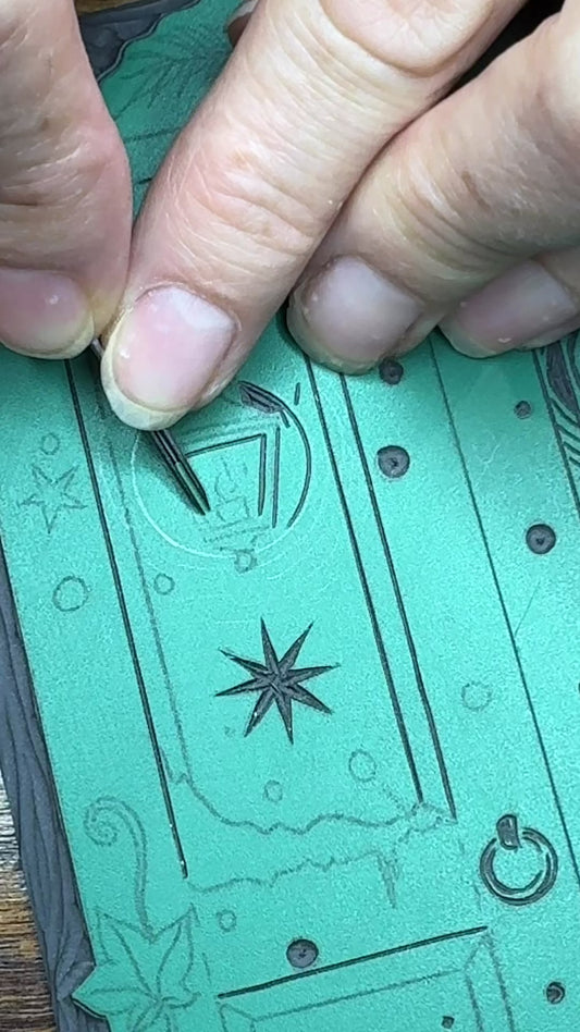 Carving of linoprint block for wardrobe Christmas card