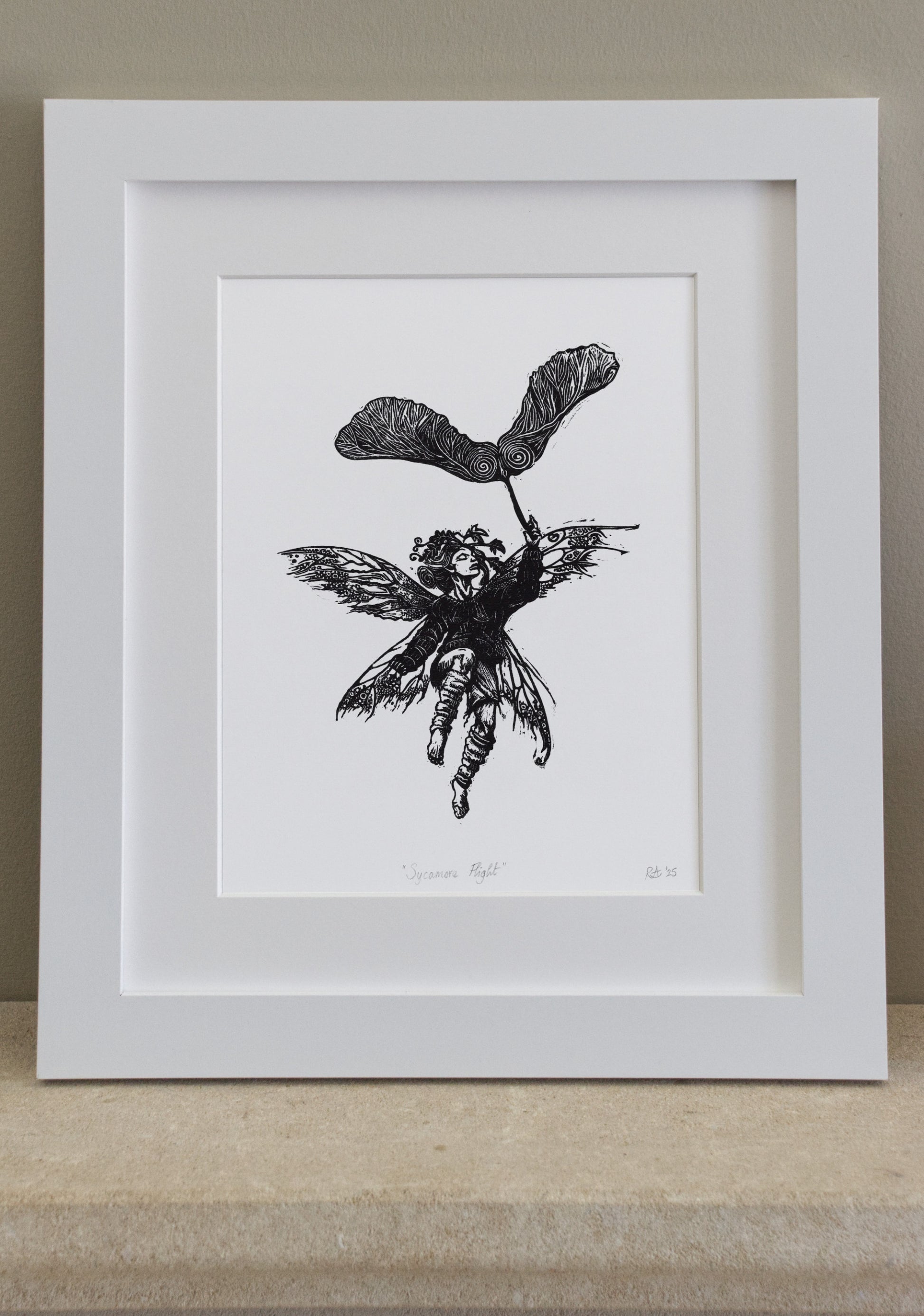Framed black and white illustration of a fairy with a leaf on a neutral background