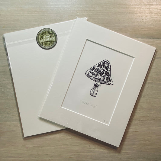 Matted artwork of a floral design on a wooden surface