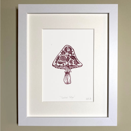 Framed Christmas artwork of a mushroom with floral design on a beige wall