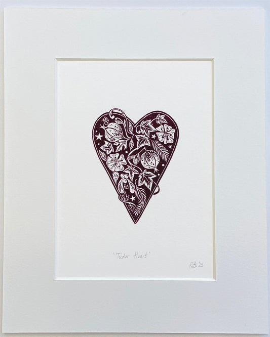 Framed artwork of a decorative heart with floral patterns on a white background